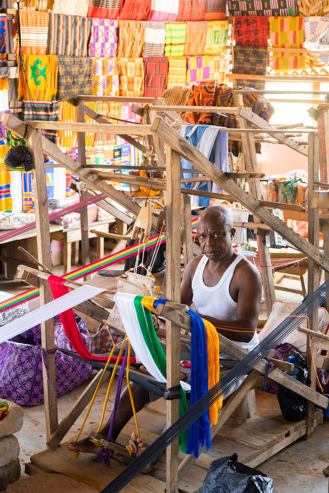 Man weaving Kente clothing in Ghana